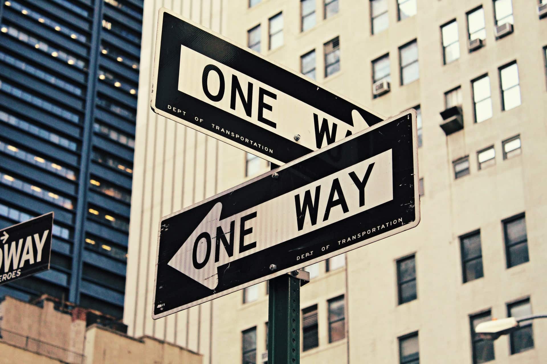 Image shows a sign pointing in two directions, illustrating the idea of a career switch.