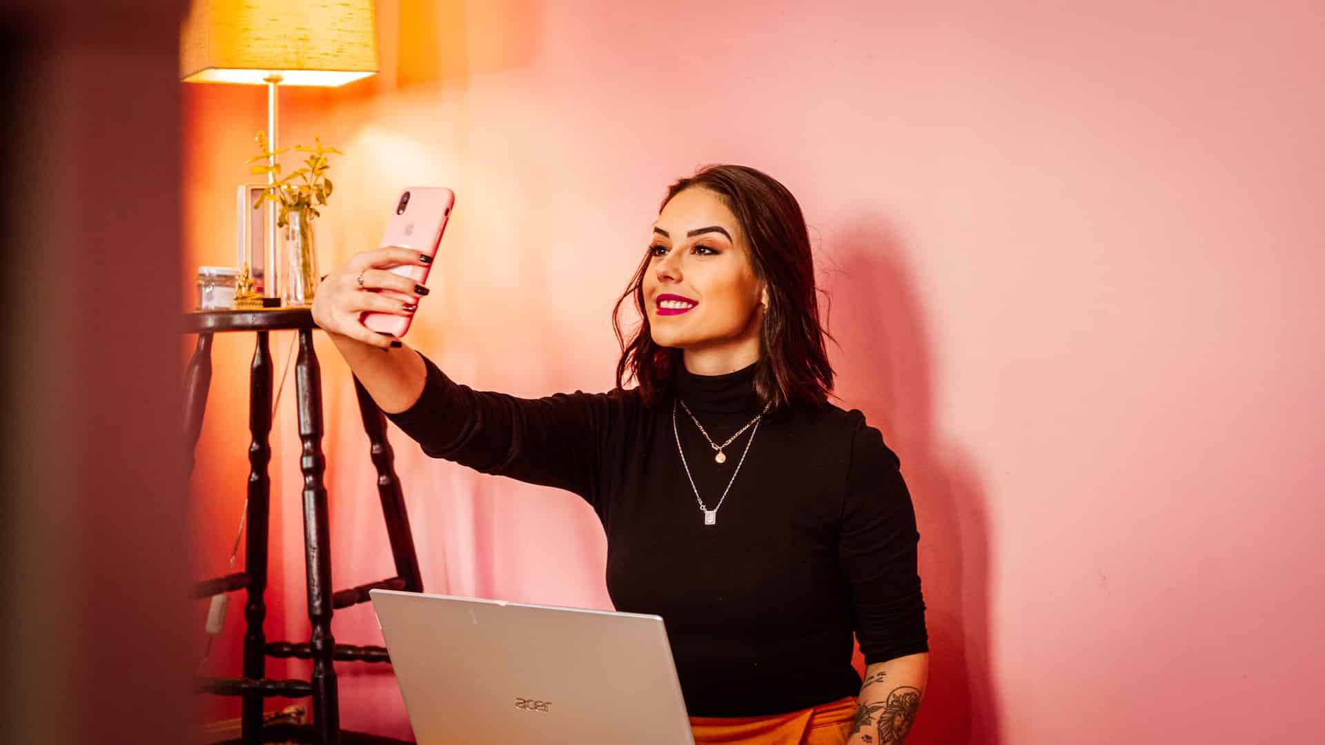 Image shows a woman taking a selfie on her phone, illustrating the concept of influencer marketing.
